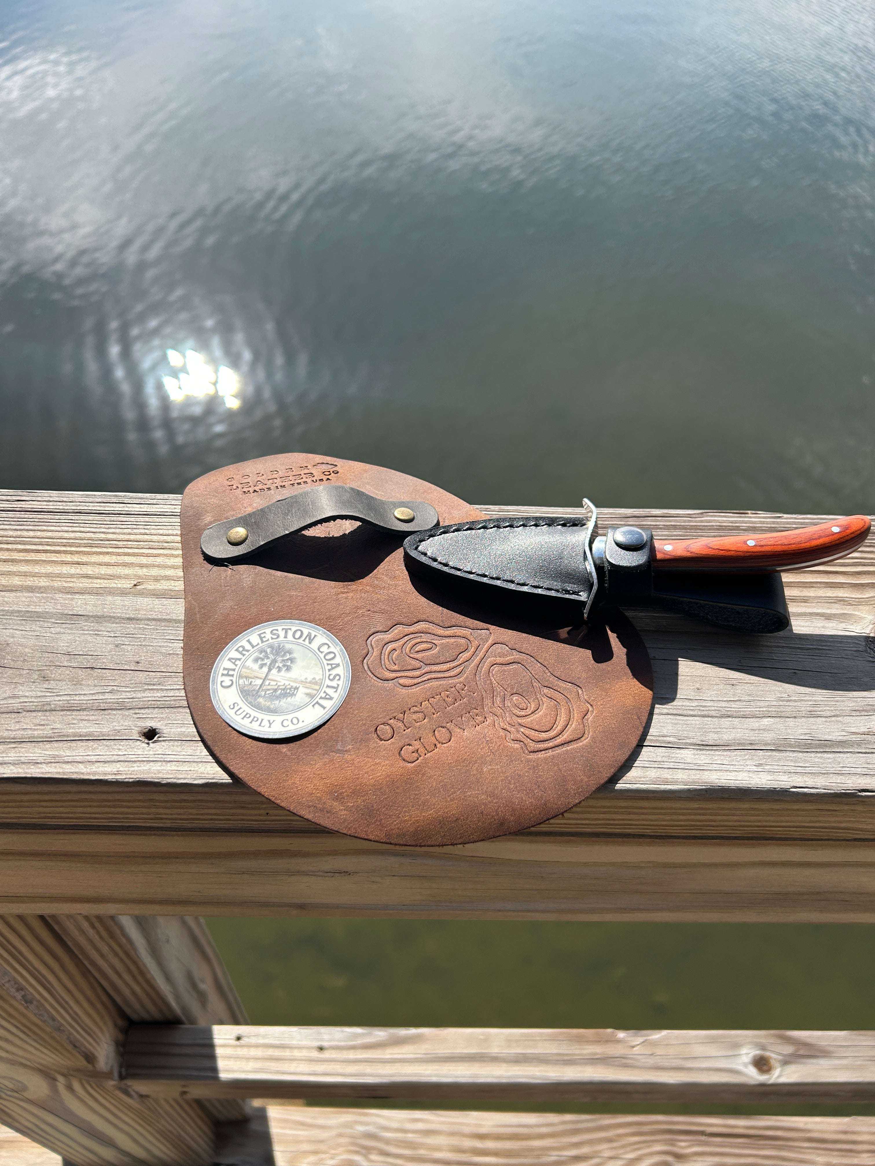 Oyster shucking kit essentials with knife, cut-resistant glove, stable board, and shell container for safe and efficient oyster preparation.