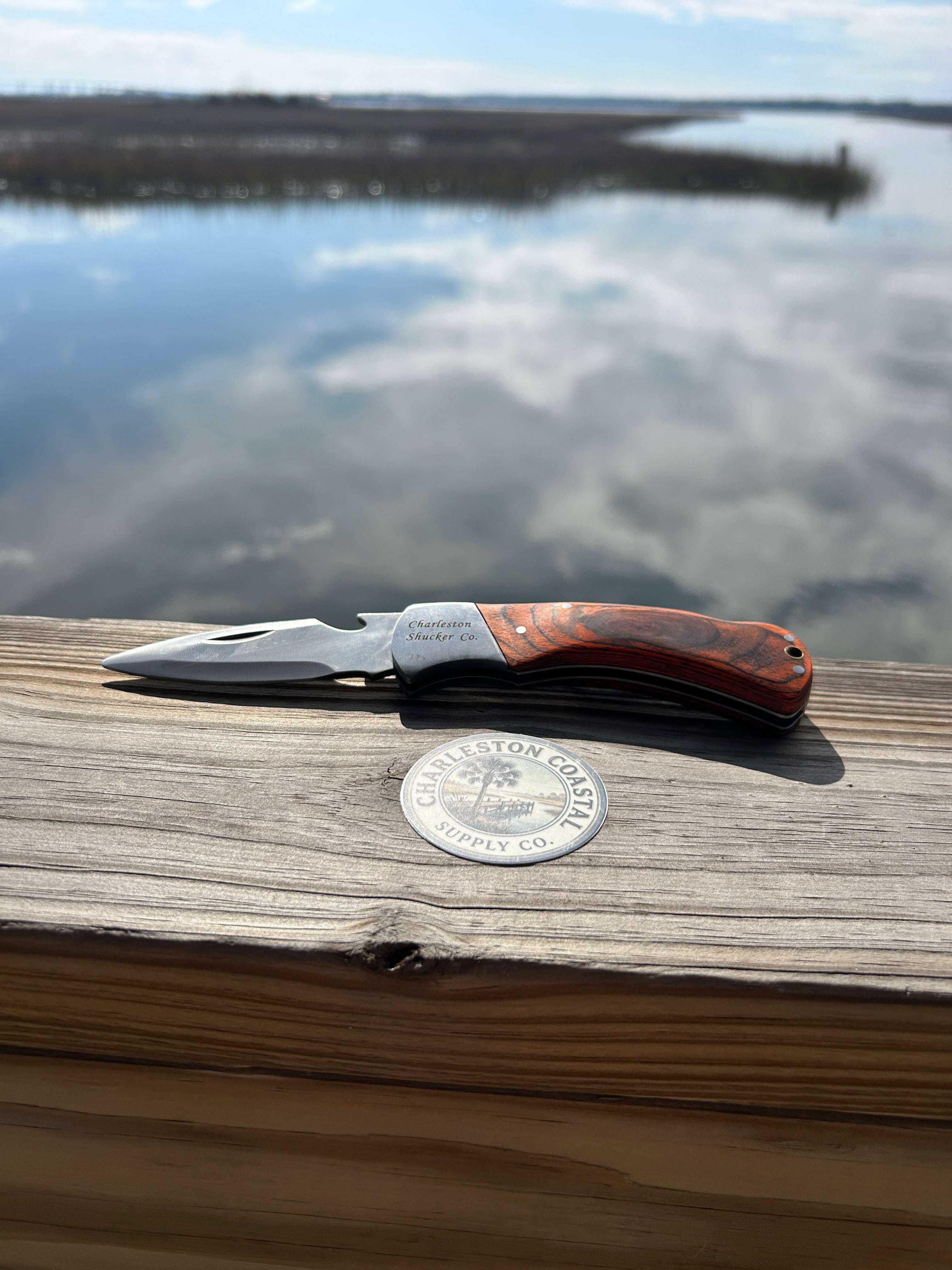 folding oyster knife bottle opener with protective sheath for coastal oyster roasts and outdoor gatherings