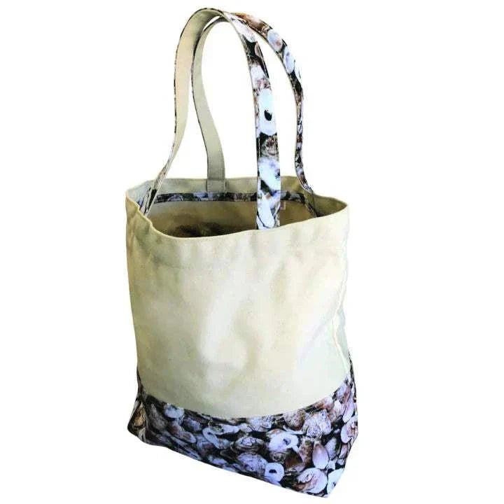Durable beach tote bag in cream canvas with shell-patterned handles and bottom, water-resistant and heavy-duty
