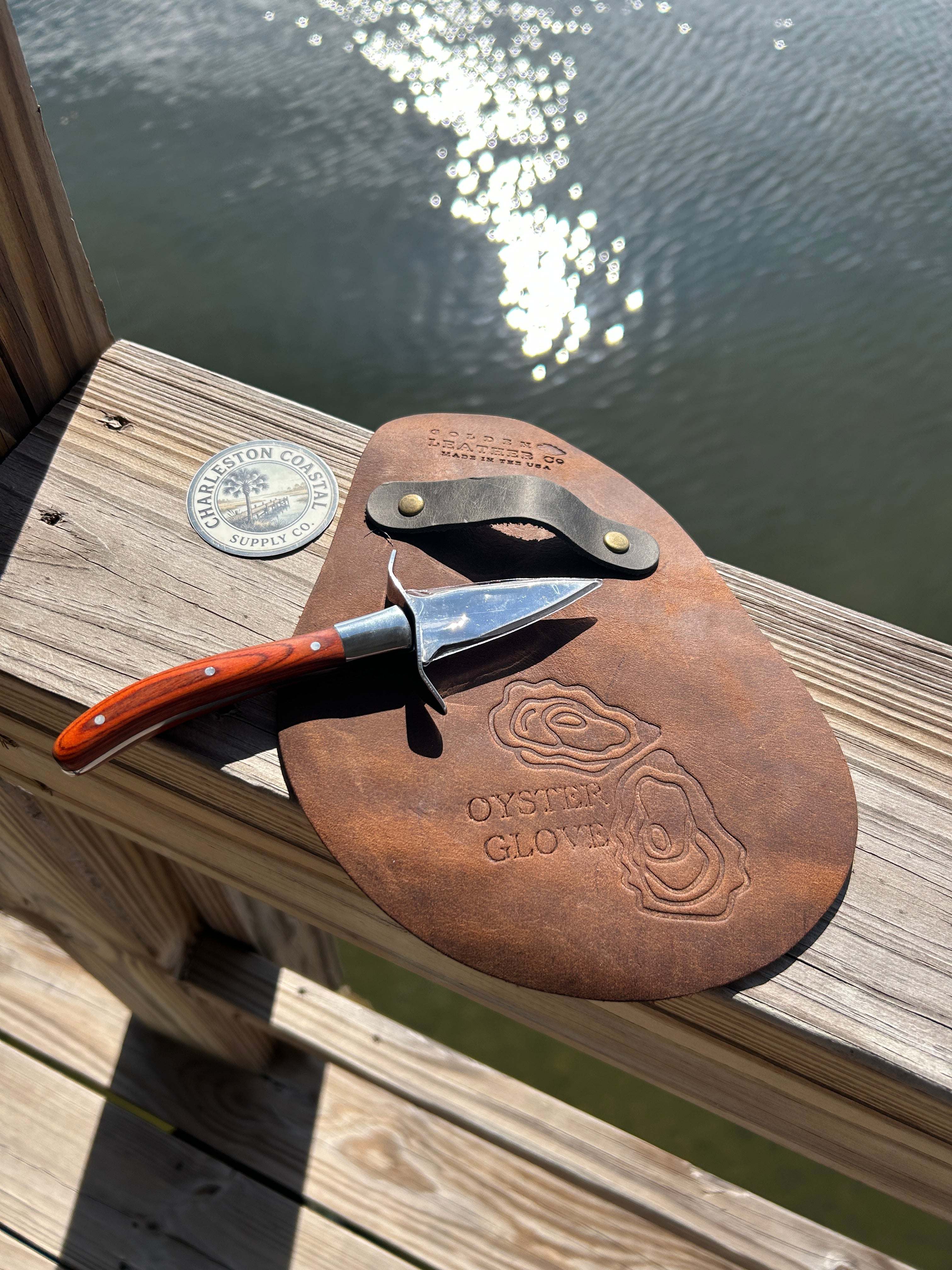Handcrafted full-grain leather shucks oyster glove with brass rivet strap and oyster artwork
